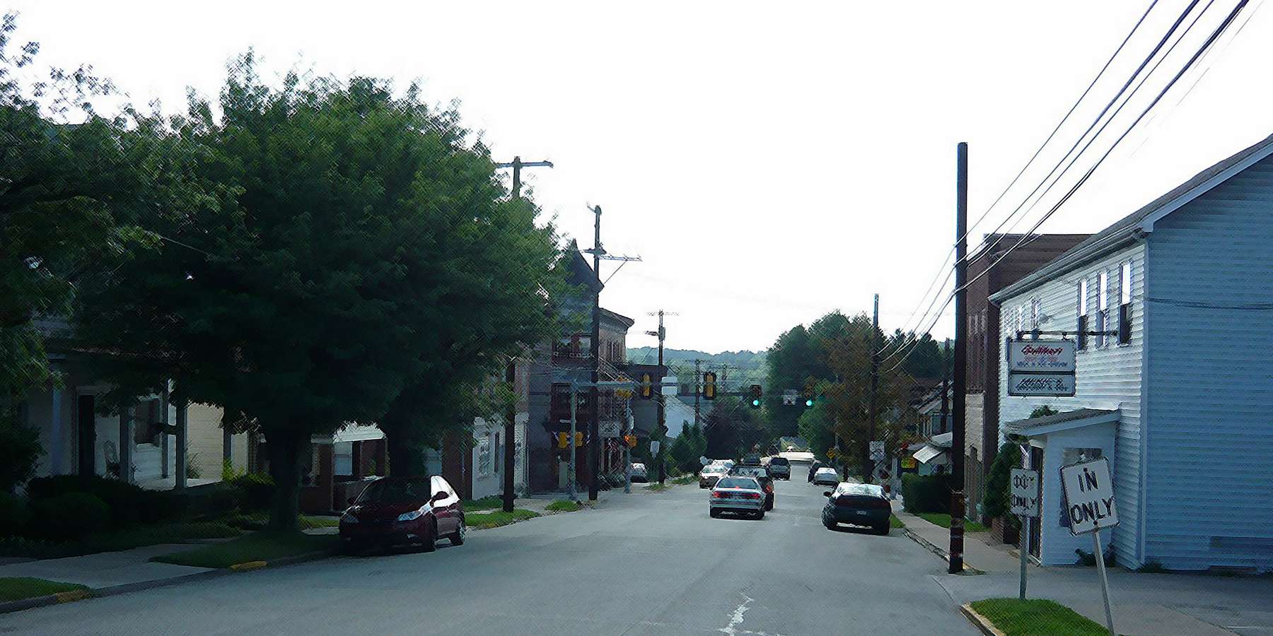 Photo of downtown with cars and houses in Youngstown, Pennsylvania Photo of downtown with cars and houses in Youngstown, Pennsylvania