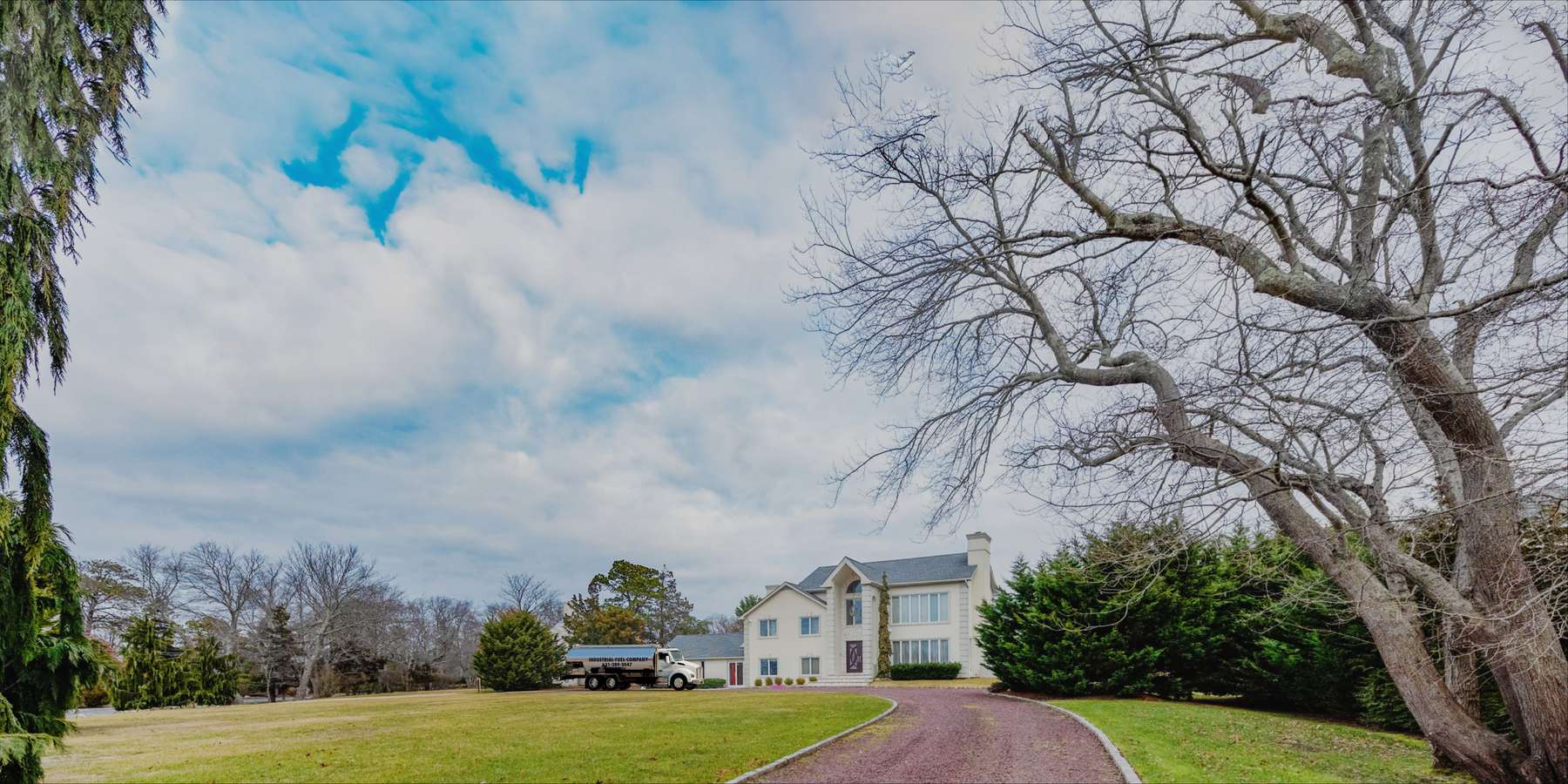 A residential heating oil truck is parked in front of a cream-colored two-story home in Cedarhurst, Long Island, New York, delivering fuel oil. A residential heating oil truck is parked in front of a cream-colored two-story home in Cedarhurst, Long Island, New York, delivering fuel oil.