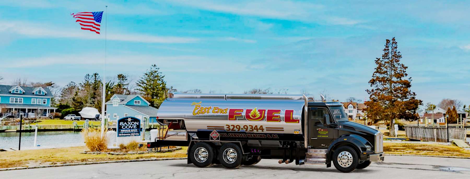 East End Container Service Heating Oil Truck East End Container Service residential home heating oil truck parked on a cul de sac along a river with an American Flag in East Islip, Long Island, New York delivering fuel oil.