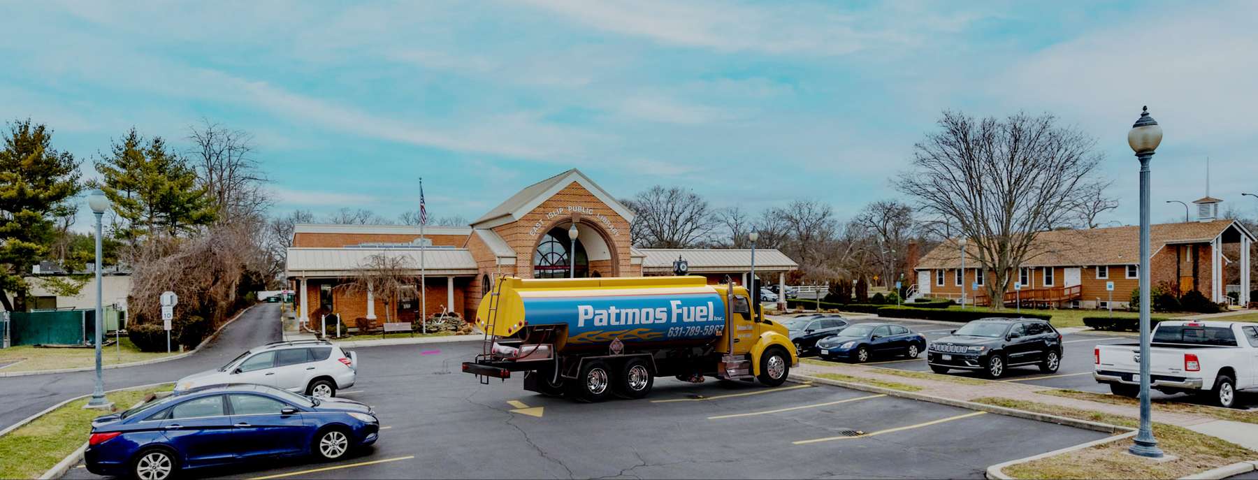 Peconic Energy Heating Oil Truck Peconic Energy residential home heating oil truck on an empty road with trees and a construction site in Holbrook, Long Island, New York delivering fuel oil.