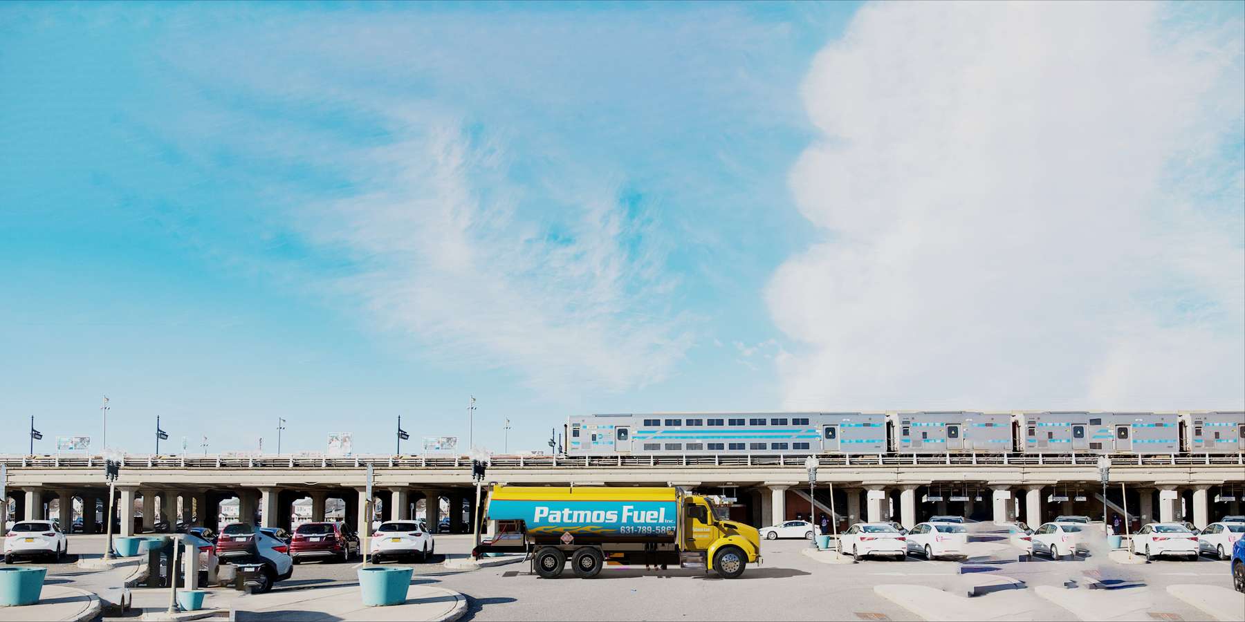 Residential heating oil truck in front of a railroad bridge in East Islip, Long Island, New York delivering fuel oil. Residential heating oil truck in front of a railroad bridge in East Islip, Long Island, New York delivering fuel oil.