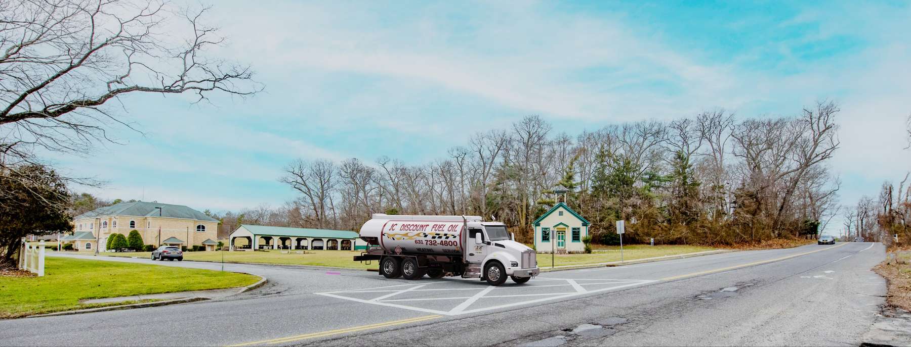 John's Fuel Heating Oil Truck John's Fuel residential home heating oil truck on a road adjacent to a brick building in Holtsville, Long Island, New York delivering fuel oil.