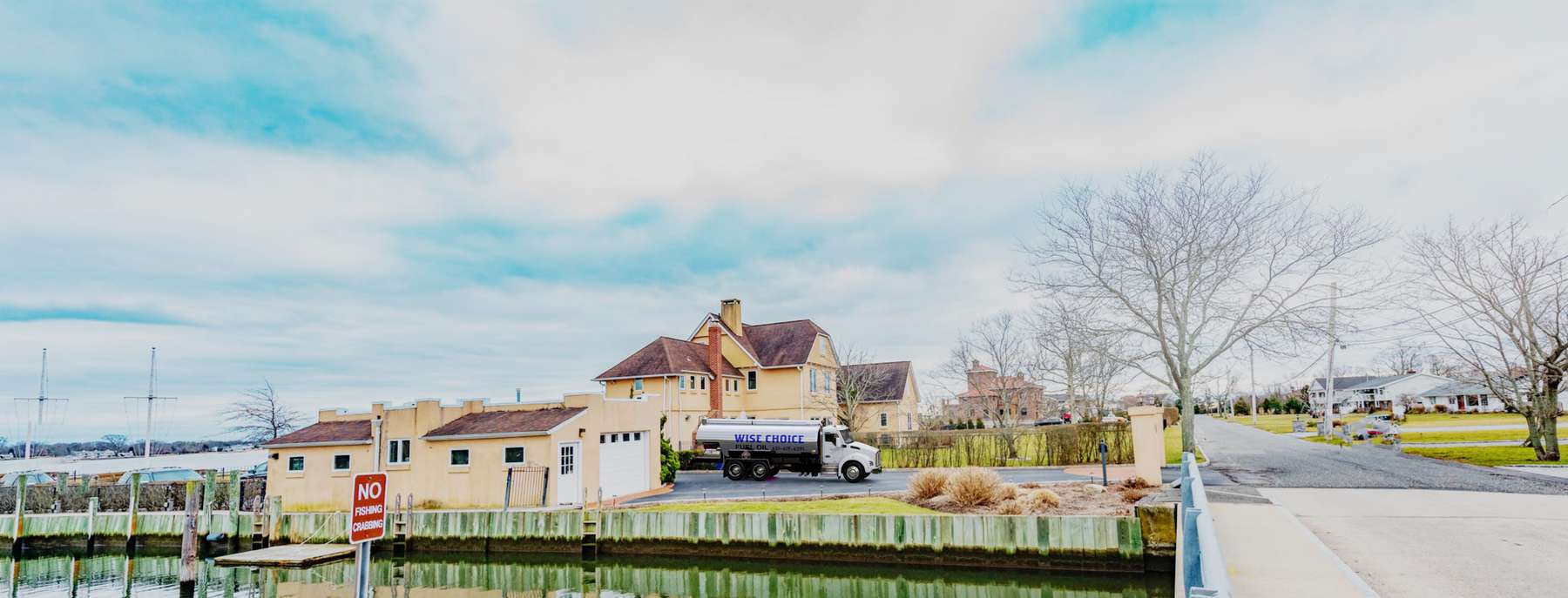 A.A. Fuel Oil Heating Oil Truck  A.A. Fuel Oil residential home heating oil truck in the driveway of a pink stucco home adjacent to a bridge and a canal in Medford, Long Island, New York delivering fuel oil.