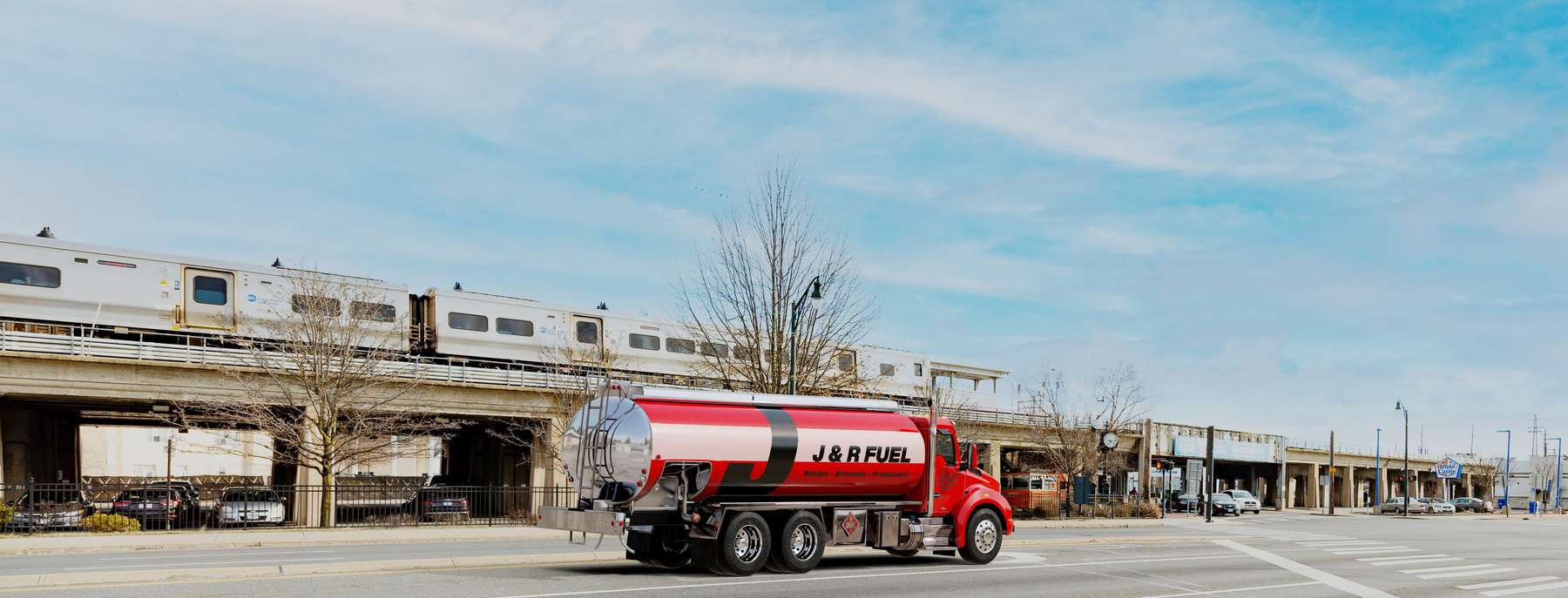 J & R Fuel Heating Oil Truck J & R Fuel residential home heating oil truck parked at the LIRR station with an eastbound train pulling into the station in Central Islip, Long Island, New York delivering fuel oil.