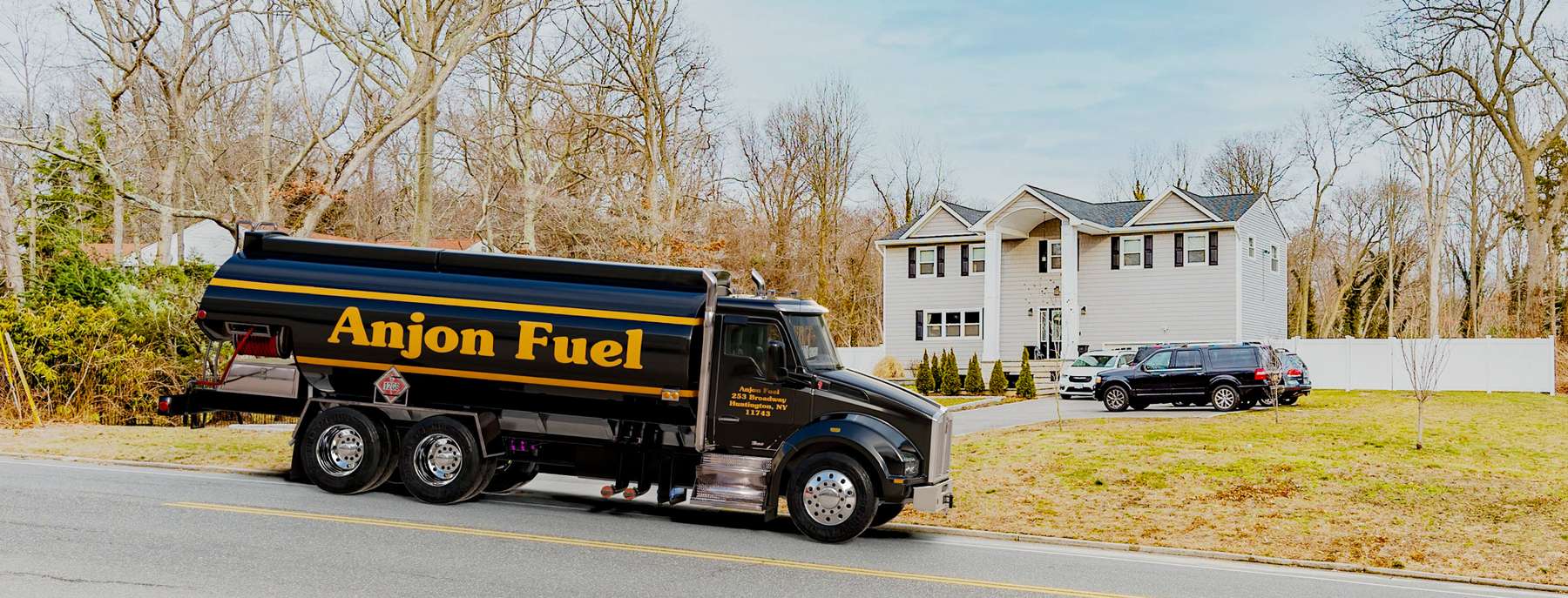 Anjon Heating Oil Truck Anjon residential home heating oil truck in front of a gray single family residence in Huntington, Long Island, New York delivering fuel oil.