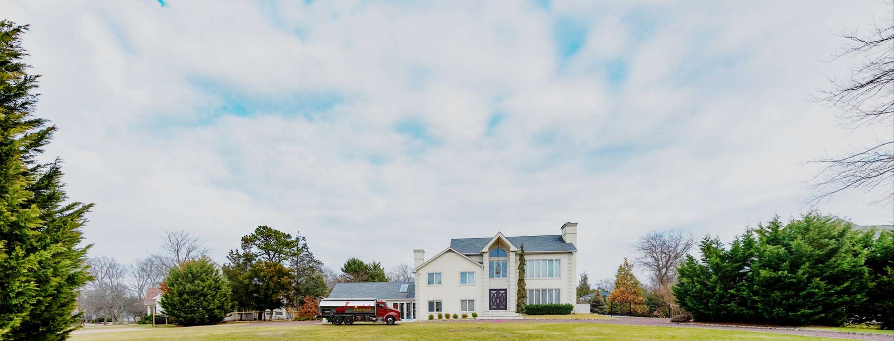 Jarzombek Energy Heating Oil Truck Jarzombek Energy residential home heating oil truck in front of a large 5 bedroom stucco home in Calverton, Long Island, New York delivering fuel oil.