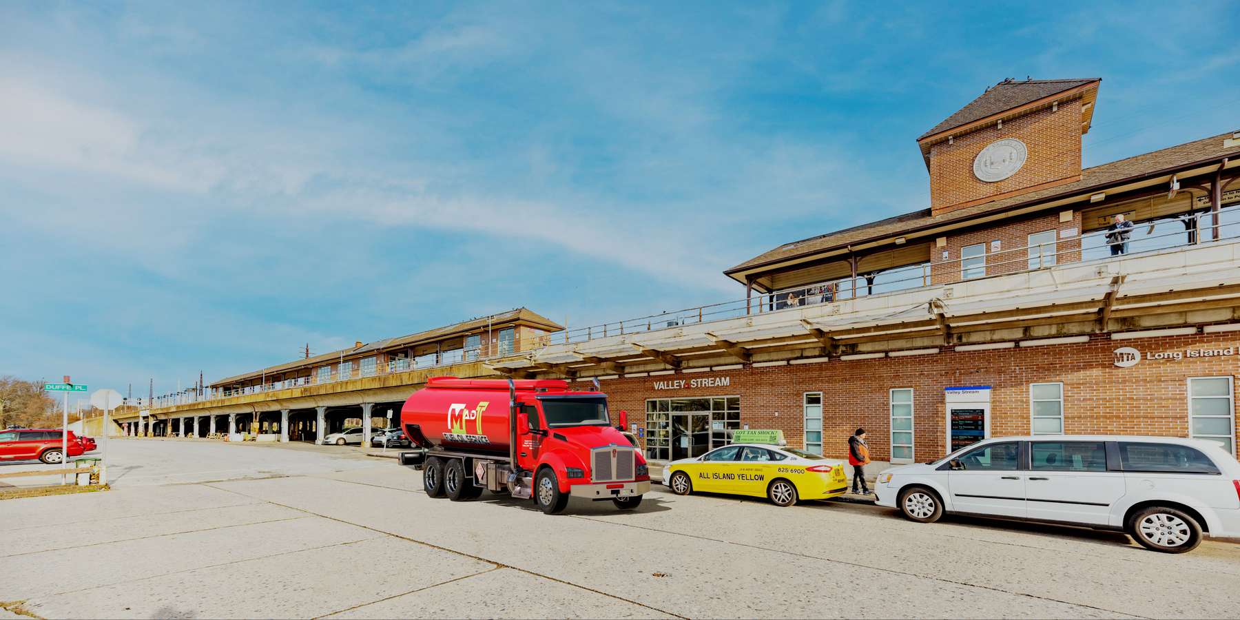 Residential heating oil truck at the entrance to the LIRR station in Valley Stream, Long Island, New York delivering fuel oil. Residential heating oil truck at the entrance to the LIRR station in Valley Stream, Long Island, New York delivering fuel oil.