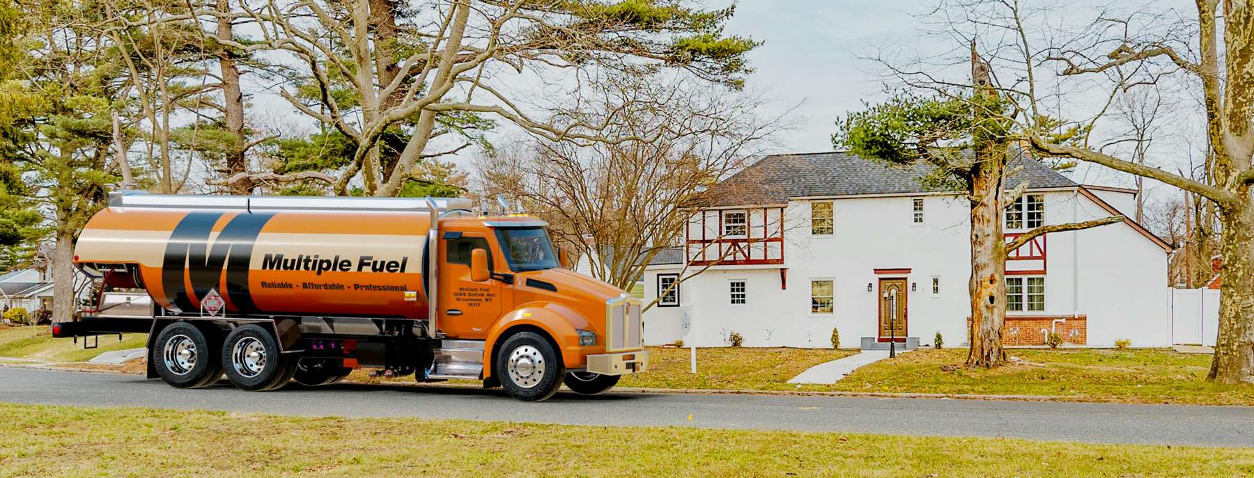 Multiple Fuel Heating Oil Truck Multiple Fuel residential home heating oil truck with a white house in Brentwood, Long Island, New York delivering fuel oil.