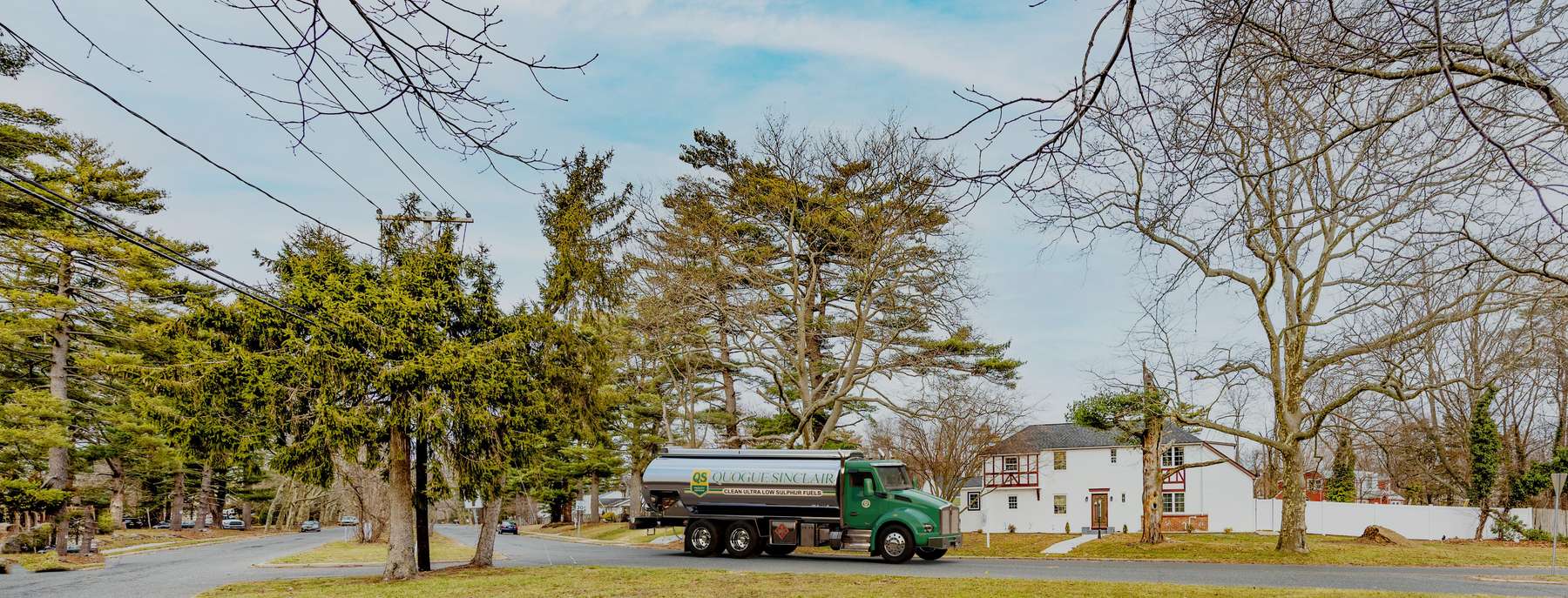 Quogue Sinclair Fuel Heating Oil Truck Quogue Sinclair Fuel residential home heating oil truck parked in front of a white tudor mansion on Weald Road in Brentwood, Long Island, New York delivering fuel oil.