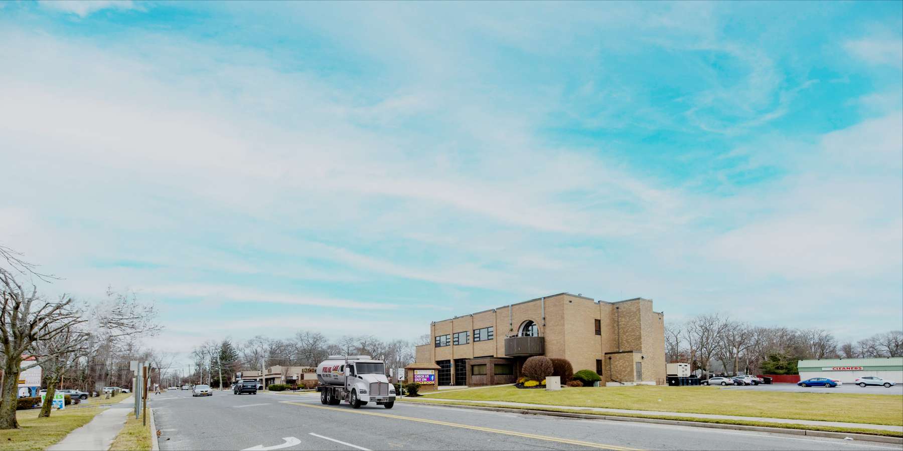 Residential heating oil truck parked in front of the city firehouse in Holtsville, Long Island, New York delivering fuel oil. Residential heating oil truck parked in front of the city firehouse in Holtsville, Long Island, New York delivering fuel oil.