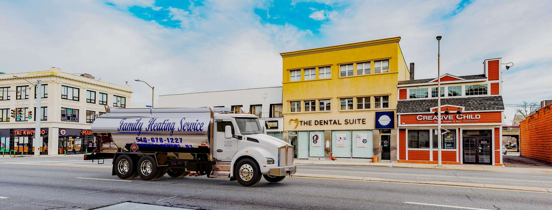 Suffolkoil Heating Oil Truck Suffolkoil residential home heating oil truck in front of a brick and stucco building in Medford, Long Island, New York delivering fuel oil.