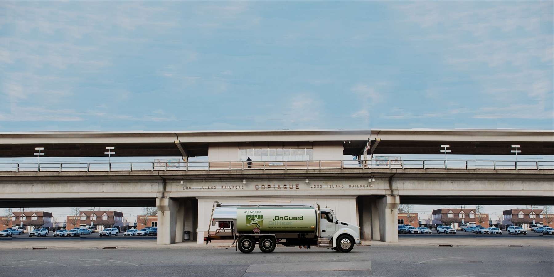 Residential heating oil truck at the LIRR station in Copiague, Long Island, New York delivering fuel oil. Residential heating oil truck at the LIRR station in Copiague, Long Island, New York delivering fuel oil.