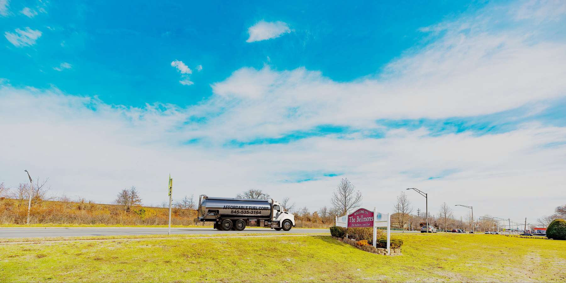 Residential heating oil truck with the Welcome To The Bellmores sign in Bellmore, Long Island, New York delivering fuel oil. Residential heating oil truck with the Welcome To The Bellmores sign in Bellmore, Long Island, New York delivering fuel oil.