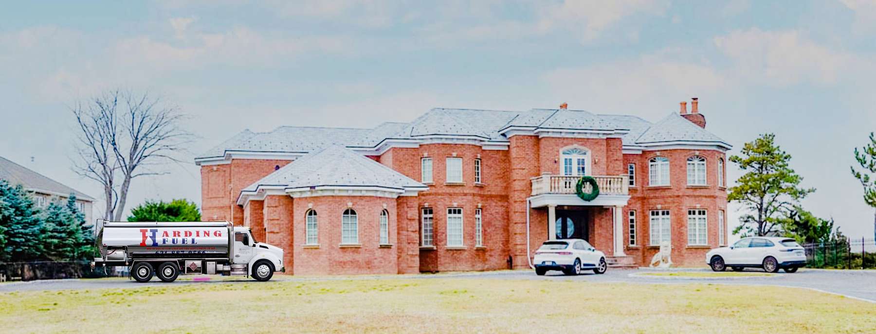 Harding Fuel Heating Oil Truck Harding Fuel residential home heating oil truck in front a brick residence in Bridgehampton, Long Island, New York delivering fuel oil.