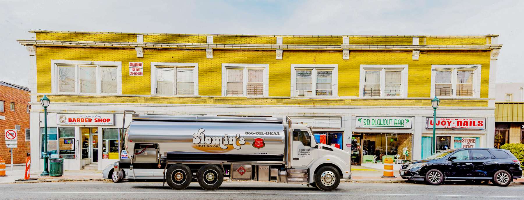 Slomin's Inc Heating Oil Truck Slomin's Inc residential home heating oil truck downtown in Baldwin, Long Island, New York delivering fuel oil.