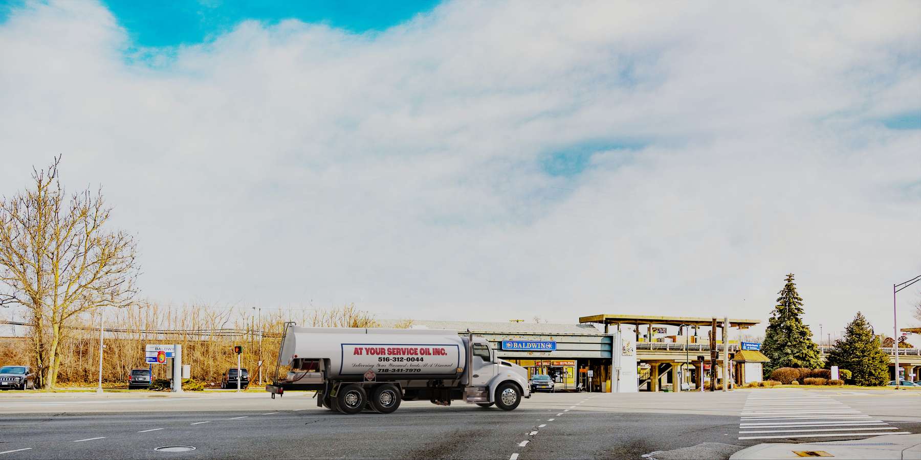 Residential heating oil truck with the Beautiful Baldwin sign in Baldwin, Long Island, New York delivering fuel oil. Residential heating oil truck with the Beautiful Baldwin sign in Baldwin, Long Island, New York delivering fuel oil.