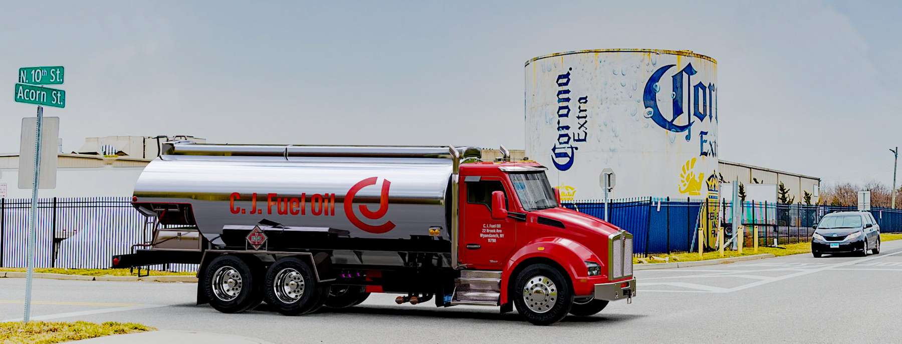 C. J. Fuel Oil Heating Oil Truck C. J. Fuel Oil residential home heating oil truck parked next to the Corona Extra fuel storage tank in Wyandanch, Long Island, New York delivering fuel oil.